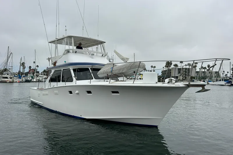 Slide: The Image of 1976 Pacifica Flybridge yacht cruising in a marina with overcast skies. - 3