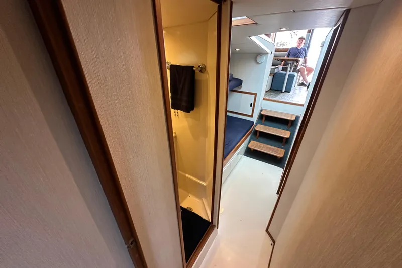 Slide: The Image of Interior view of a 1976 Pacifica Flybridge boat, featuring a cozy cabin and seating area. - 31