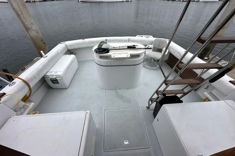 Slide: The Image of 1976 Pacifica Flybridge boat deck with seating and fishing equipment. - 33