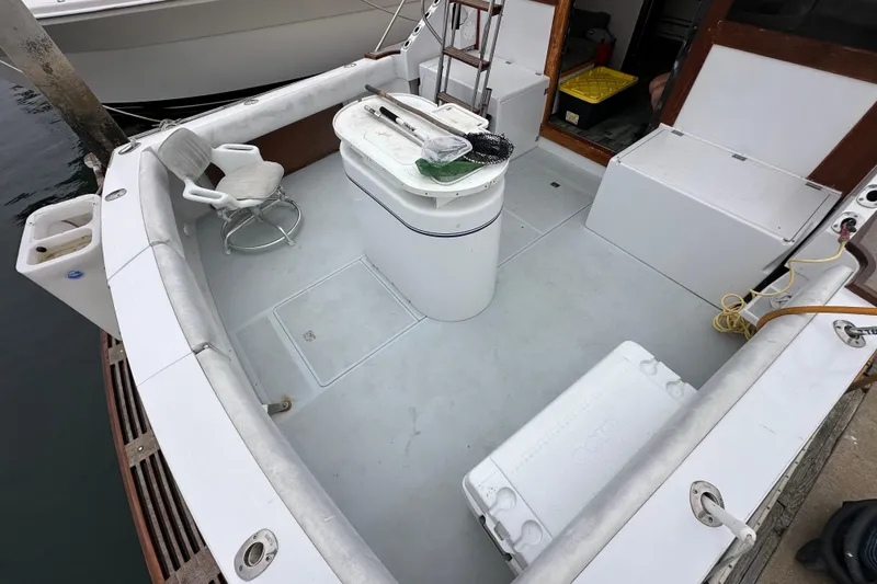 Slide: The Image of 1976 Pacifica Flybridge boat deck with seating, storage, and fishing equipment. - 38