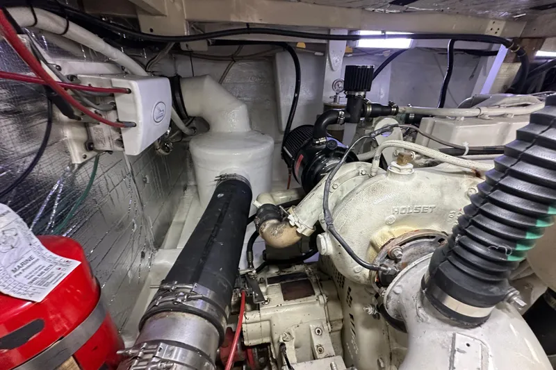 Slide: The Image of Engine room of a 1976 Pacifica Flybridge boat, featuring mechanical components and wiring. - 9