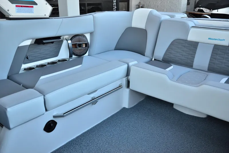 Slide: The Image of 2024 MasterCraft X22 boat interior with luxurious seating and built-in speakers. - 10