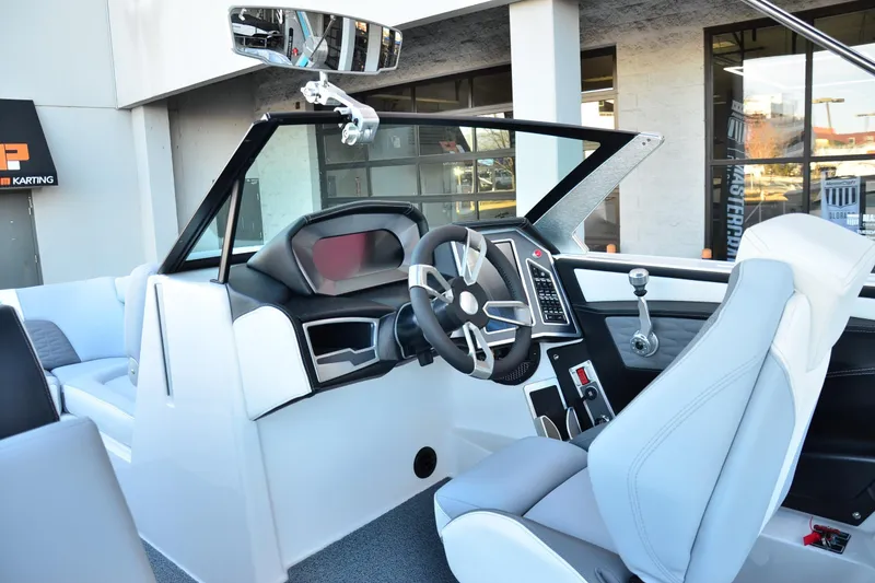 Slide: The Image of 2024 MasterCraft X22 boat interior with modern steering and dashboard design. - 11