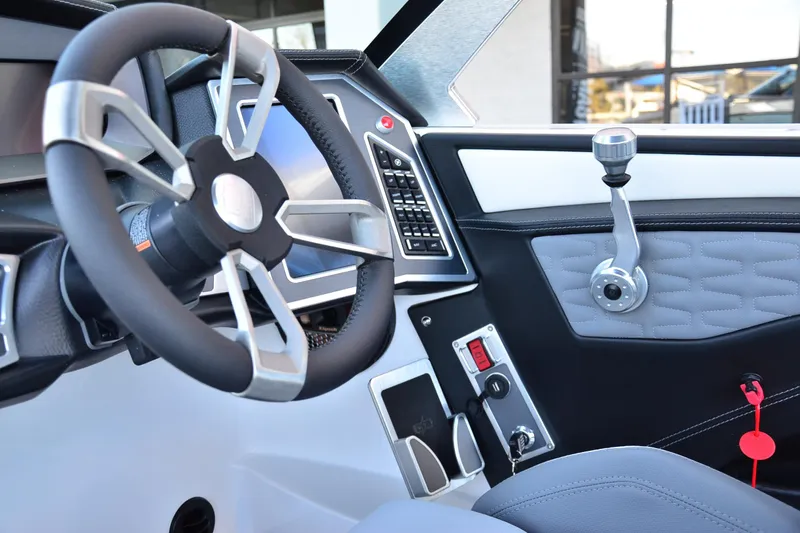 Slide: The Image of 2024 MasterCraft X22 boat interior with modern steering wheel and control panel. - 12
