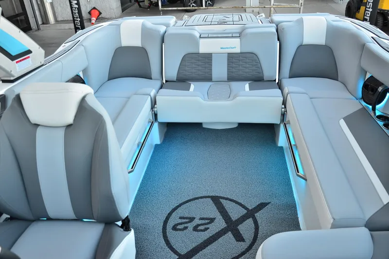 Slide: The Image of 2024 MasterCraft X22 boat interior with luxurious seating and ambient lighting. - 15