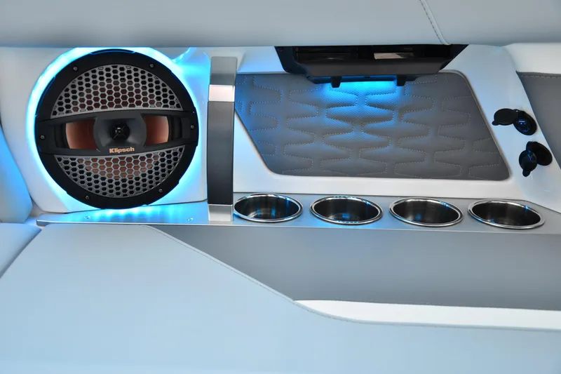 Slide: The Image of 2024 MasterCraft X22 interior with Klipsch speaker, blue LED lighting, and stainless steel cup holders. - 19