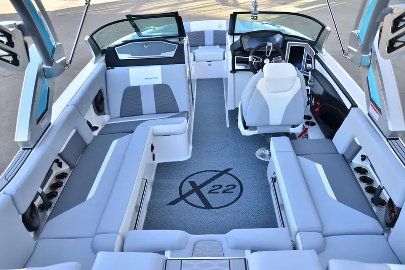 Slide: The Image of 2024 MasterCraft X22 boat interior with sleek seating and modern dashboard design. - 22