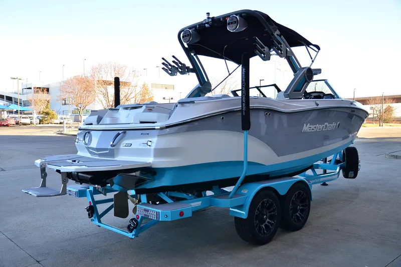 Slide: The Image of 2024 MasterCraft X22 boat on trailer, showcasing sleek design and modern features. - 3