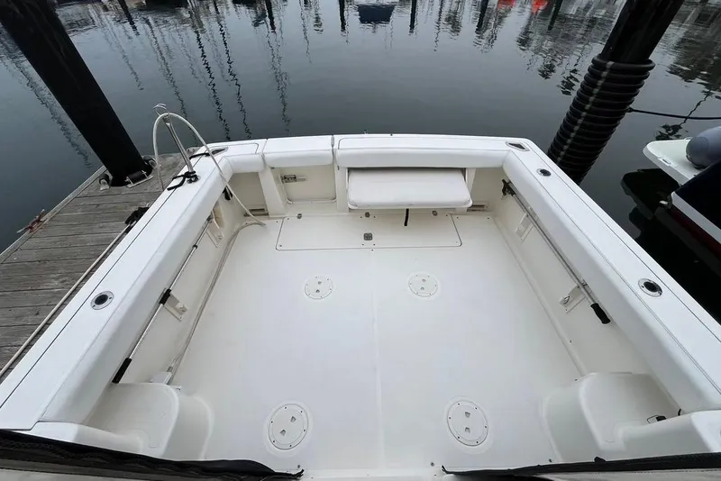 Slide: The Image of 2005 Pursuit 3100 Offshore boat cockpit, spacious and clean, docked at marina. - 10