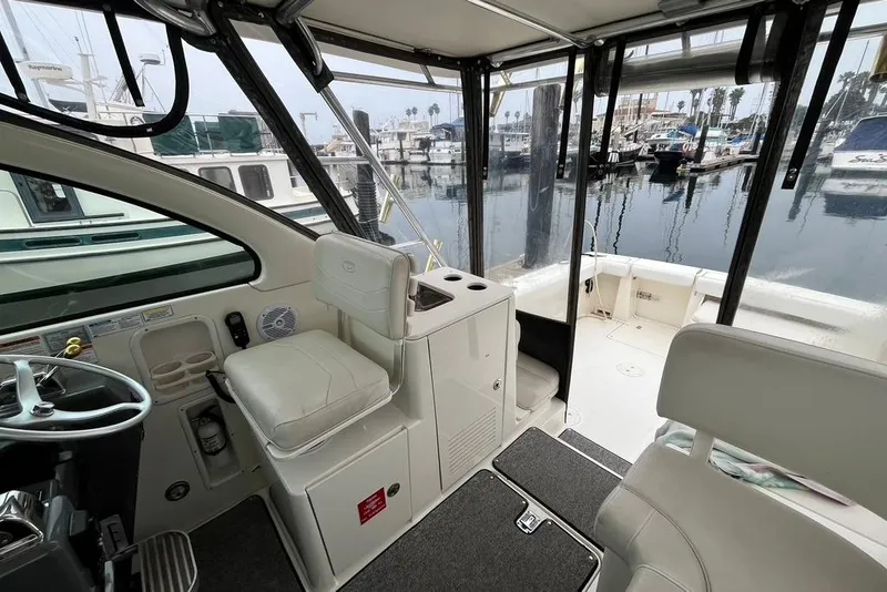 Slide: The Image of Interior view of a 2005 Pursuit 3100 Offshore boat at a marina. - 16