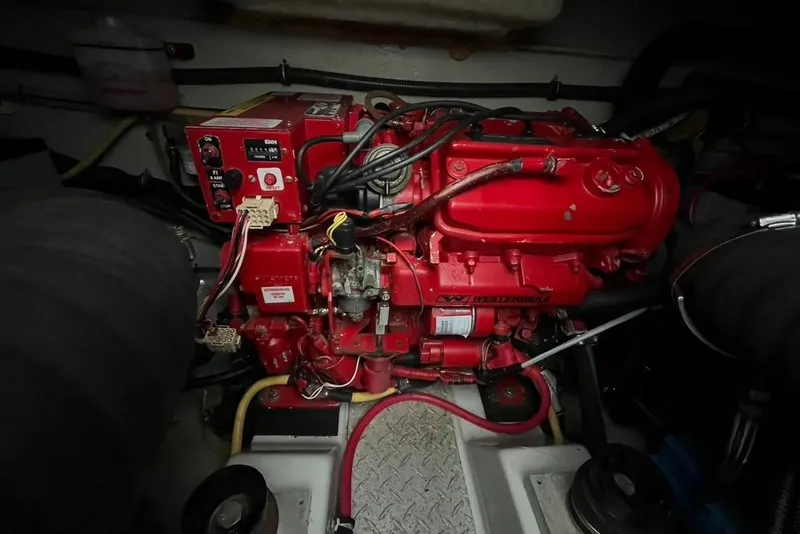 Slide: The Image of Engine compartment of a 2005 Pursuit 3100 Offshore boat, featuring a red engine. - 21