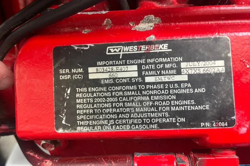 Slide: The Image of Westerbeke engine label on a 2005 Pursuit 3100 Offshore boat, showing specifications and compliance details. - 24