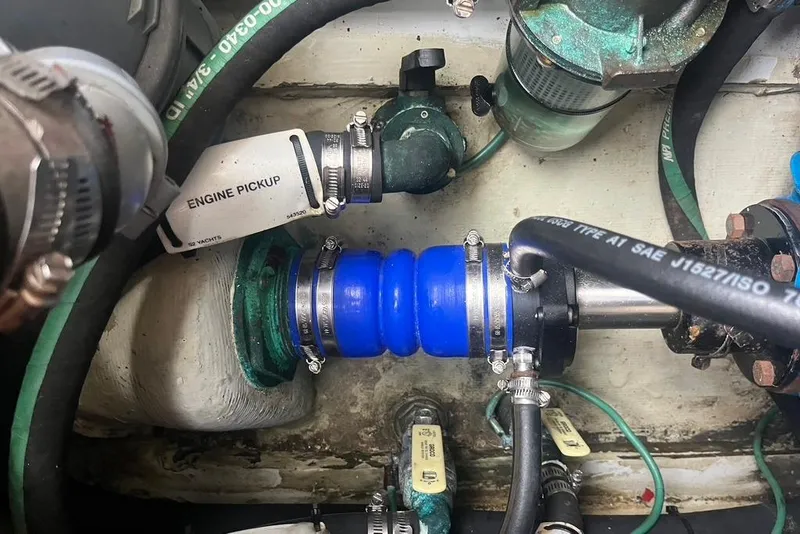 Slide: The Image of Engine compartment of a 2005 Pursuit 3100 Offshore boat, showing hoses and fittings. - 25