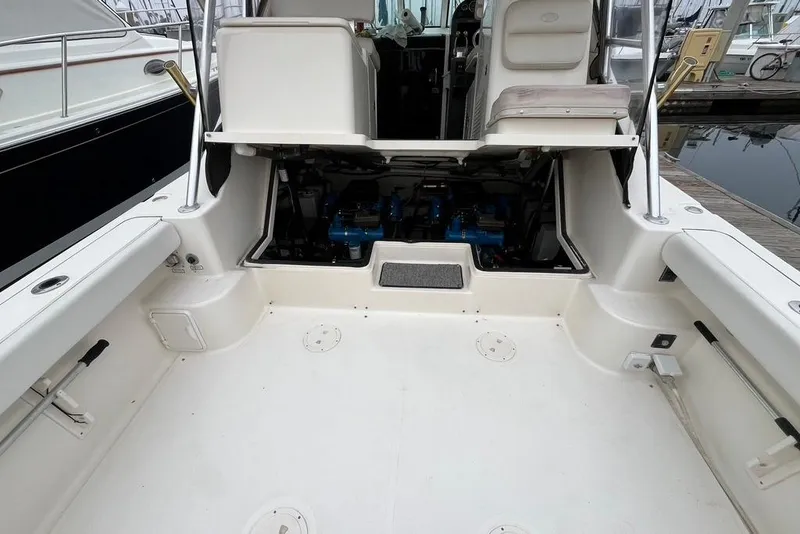 Slide: The Image of 2005 Pursuit 3100 Offshore boat with open engine compartment at dock. - 28