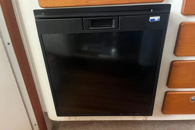 Slide: The Image of Black Norcold refrigerator in 2005 Pursuit 3100 Offshore boat interior. - 32