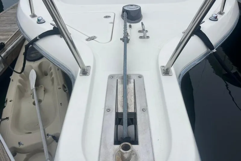 Slide: The Image of Bow view of a 2005 Pursuit 3100 Offshore boat with anchor chain and railings. - 7