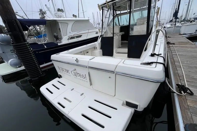 Slide: The Image of 2005 Pursuit 3100 Offshore boat docked at marina, rear view. - 9