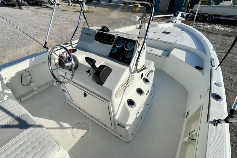 Slide: The Image of 2005 Sailfish 1900 BB Bay Boat interior with steering console and seating. - 19