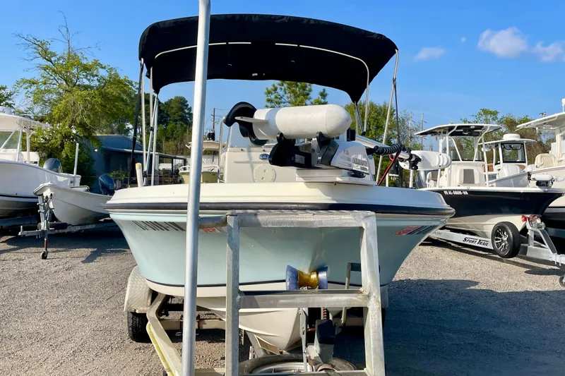 Slide: The Image of 2005 Sailfish 1900 BB Bay Boat with canopy on trailer in marina. - 2