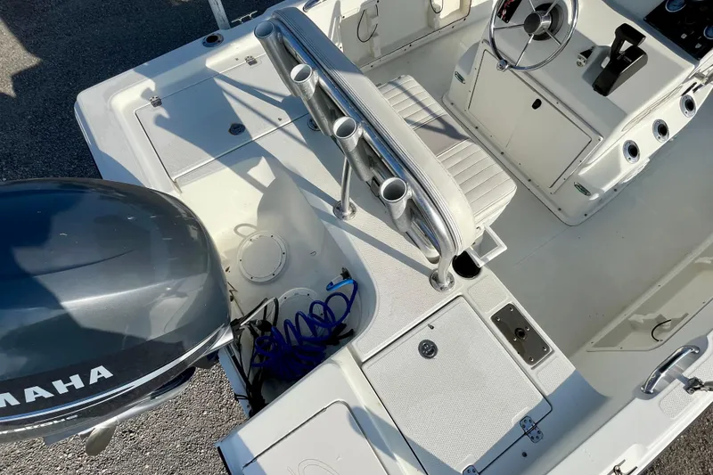 Slide: The Image of 2005 Sailfish 1900 BB Bay Boat interior with Yamaha engine, featuring seating and control console. - 21