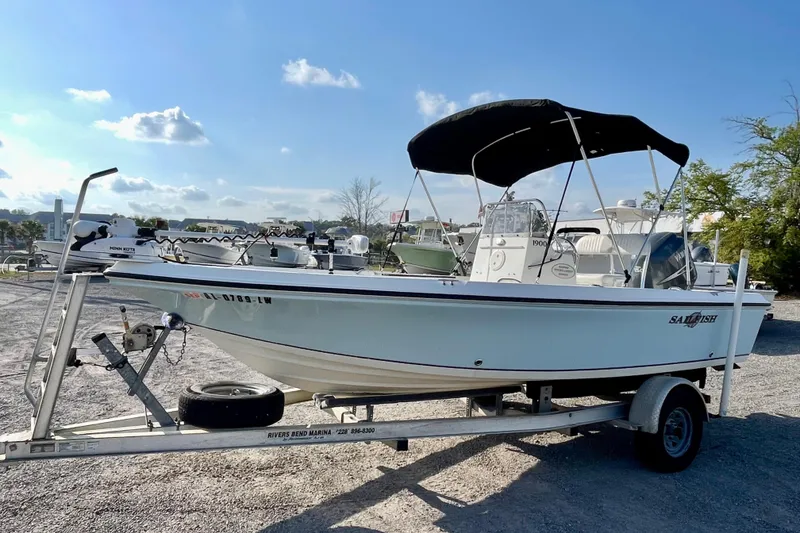Slide: The Image of 2005 Sailfish 1900 BB Bay Boat on trailer under clear blue sky. - 4