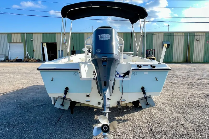 Slide: The Image of 2005 Sailfish 1900 BB Bay Boat with outboard motor, parked outdoors. - 6