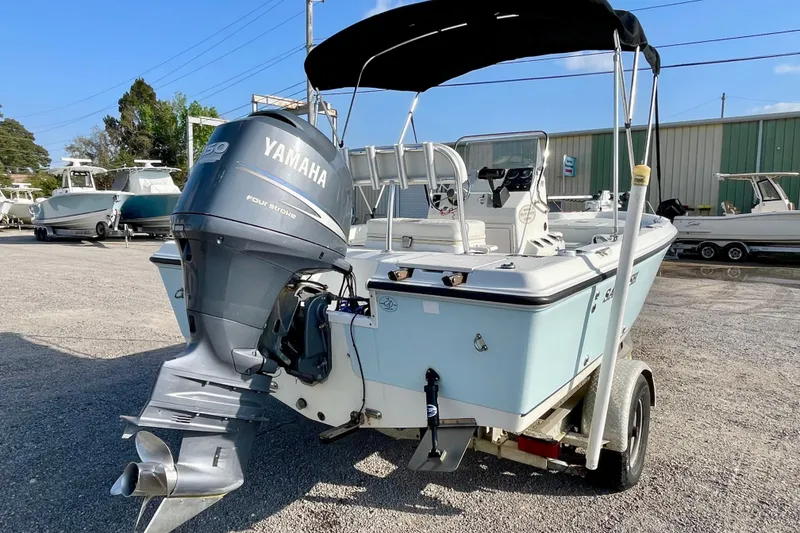 Slide: The Image of 2005 Sailfish 1900 BB Bay Boat with Yamaha engine on trailer, parked outdoors. - 7