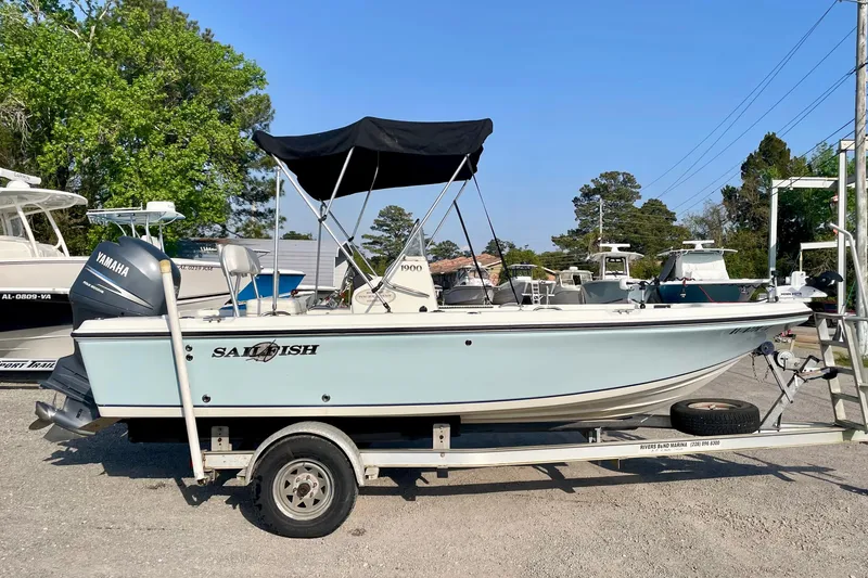 Slide: The Image of 2005 Sailfish 1900 BB Bay Boat on trailer with Yamaha engine, parked outdoors. - 9