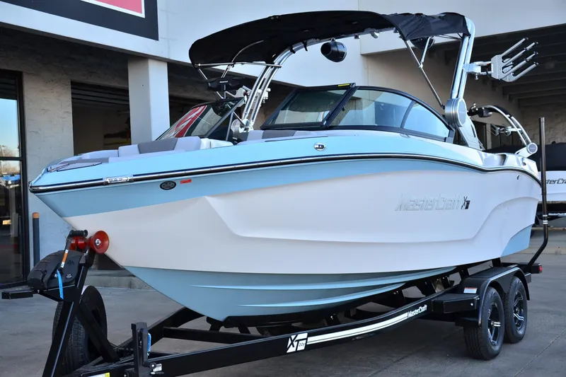 Slide: The Image of 2024 MasterCraft XT22 T boat on trailer, displayed outdoors. - 10