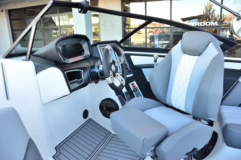 Slide: The Image of 2024 MasterCraft XT22 T boat interior with modern dashboard and comfortable seating. - 14