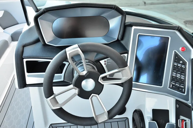 Slide: The Image of 2024 MasterCraft XT22 T dashboard with modern steering wheel and digital controls. - 16