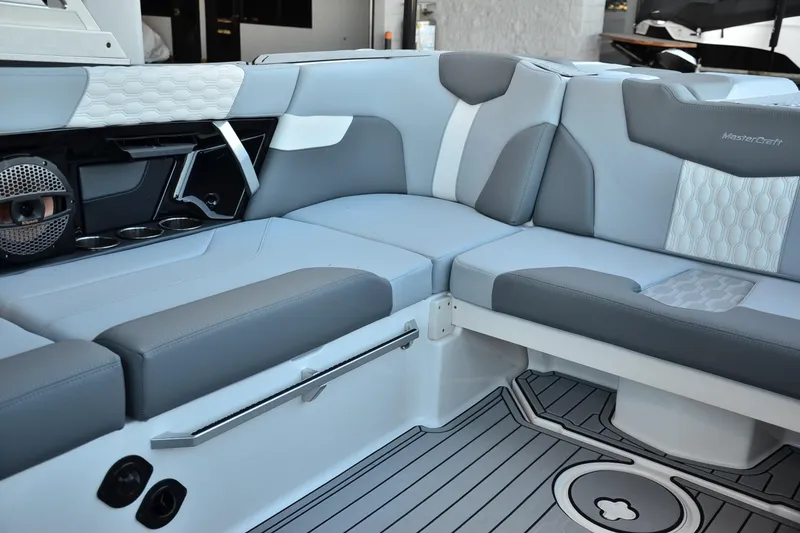 Slide: The Image of 2024 MasterCraft XT22 T boat interior with gray and white seating and modern design. - 17
