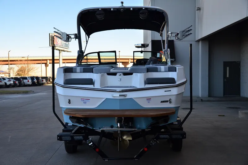 Slide: The Image of 2024 MasterCraft XT22 T boat, rear view, parked outdoors on a trailer. - 4