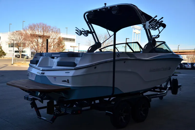 Slide: The Image of 2024 MasterCraft XT22 T boat on trailer, parked outdoors. - 5