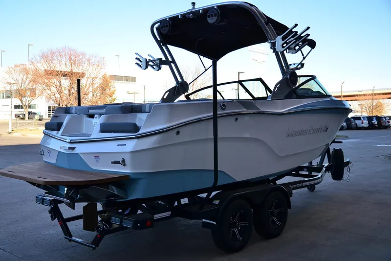 Slide: The Image of 2024 MasterCraft XT22 T boat on trailer, parked outdoors. - 6