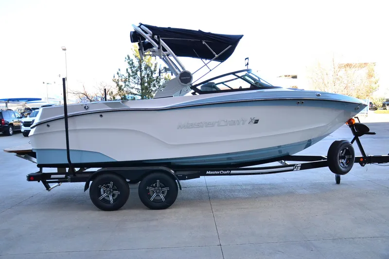 Slide: The Image of 2024 MasterCraft XT22 T boat on trailer, side view with canopy. - 7