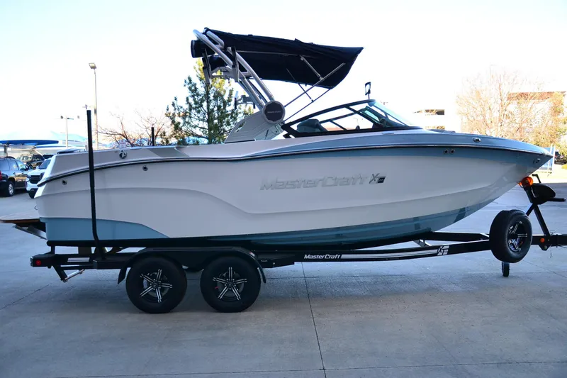 Slide: The Image of 2024 MasterCraft XT22 T boat on trailer, side view with canopy. - 8
