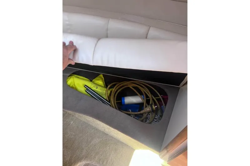 Slide: The Image of Storage compartment in 2008 Larson Cabrio 260 boat with various boating accessories. - 10