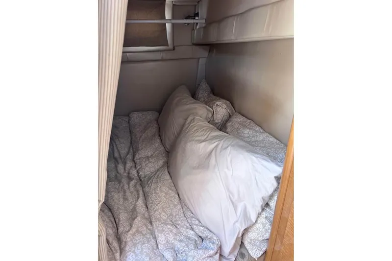Slide: The Image of Cozy sleeping area in 2008 Larson Cabrio 260 boat cabin. - 13