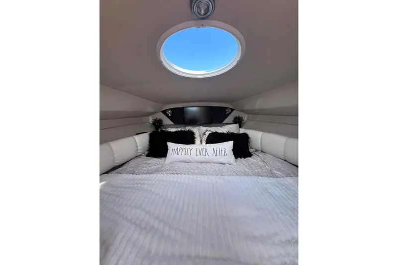 Slide: The Image of Cozy cabin interior of 2008 Larson Cabrio 260 with "Happily Ever After" pillow. - 14