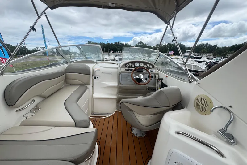 Slide: The Image of 2008 Larson Cabrio 260 boat interior with seating, steering wheel, and dashboard. - 18