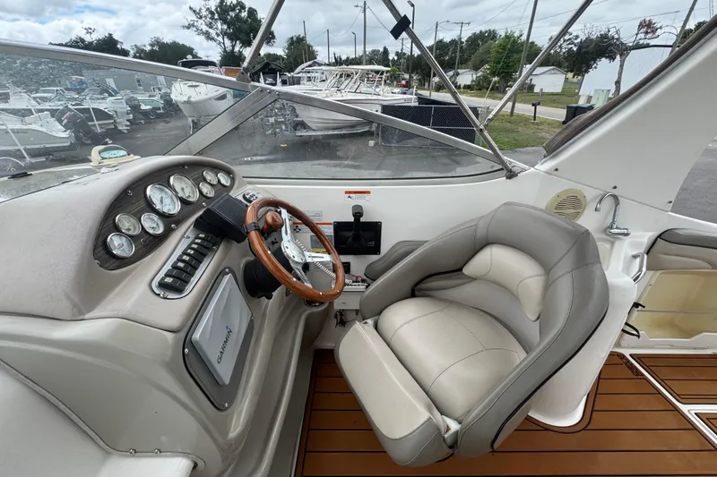 Slide: The Image of 2008 Larson Cabrio 260 boat cockpit with steering wheel and control panel. - 20