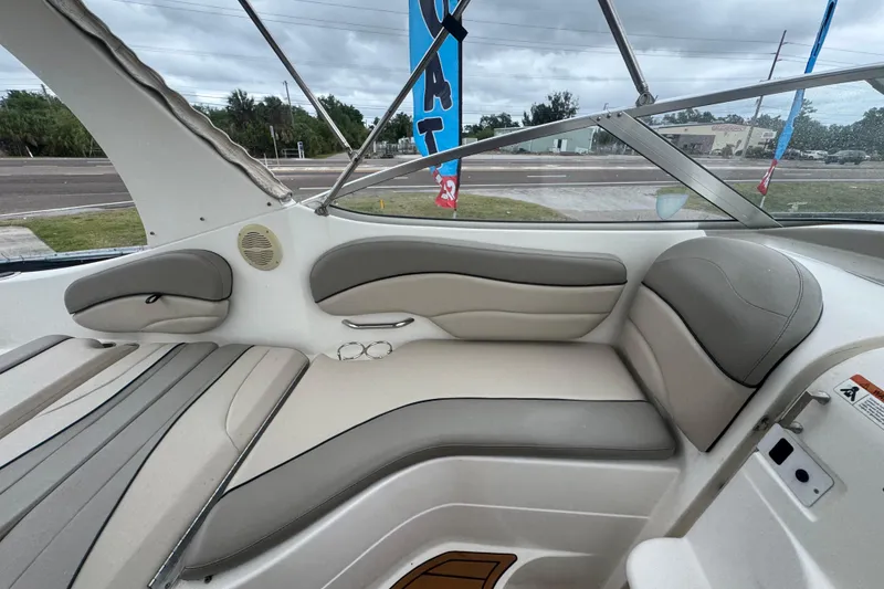 Slide: The Image of 2008 Larson Cabrio 260 boat interior with cushioned seating and sleek design. - 25