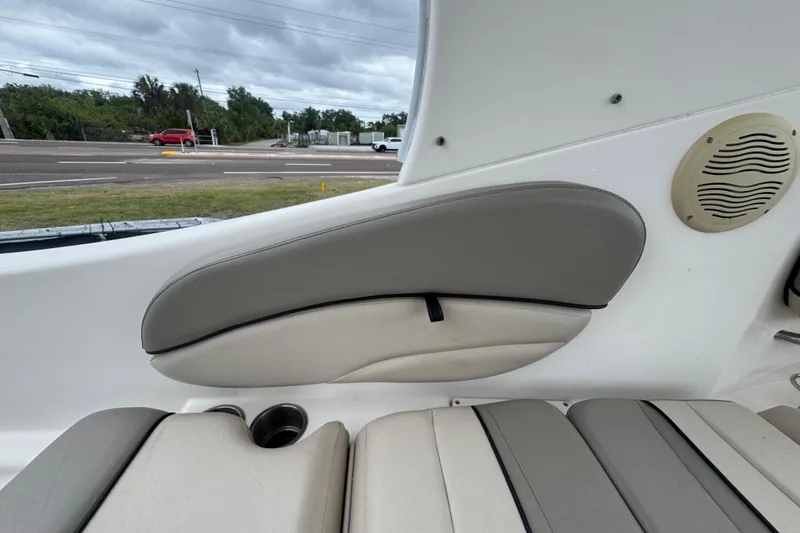Slide: The Image of 2008 Larson Cabrio 260 boat interior with cushioned seating and speaker detail. - 26
