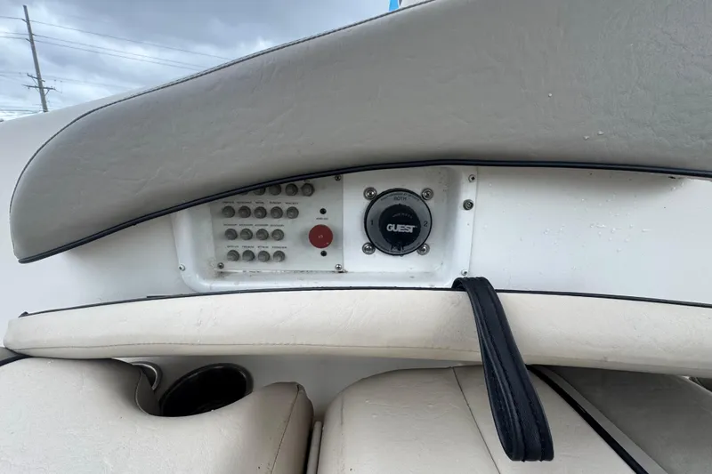Slide: The Image of Control panel of a 2008 Larson Cabrio 260 boat with switches and dials. - 27