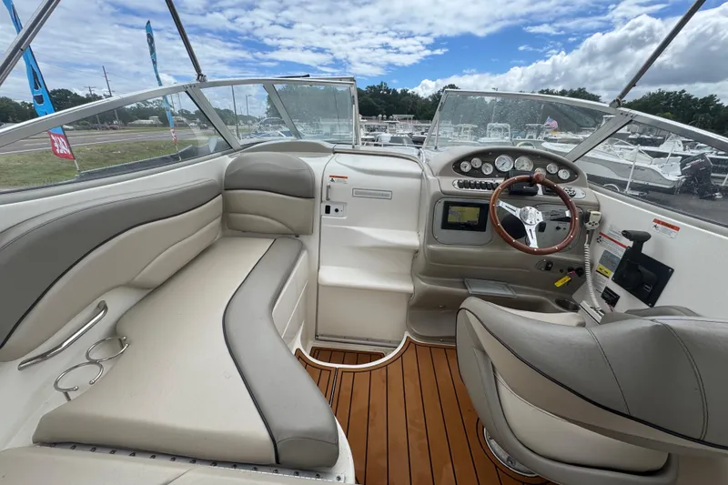 Slide: The Image of 2008 Larson Cabrio 260 boat interior with steering wheel, seating, and dashboard controls. - 28