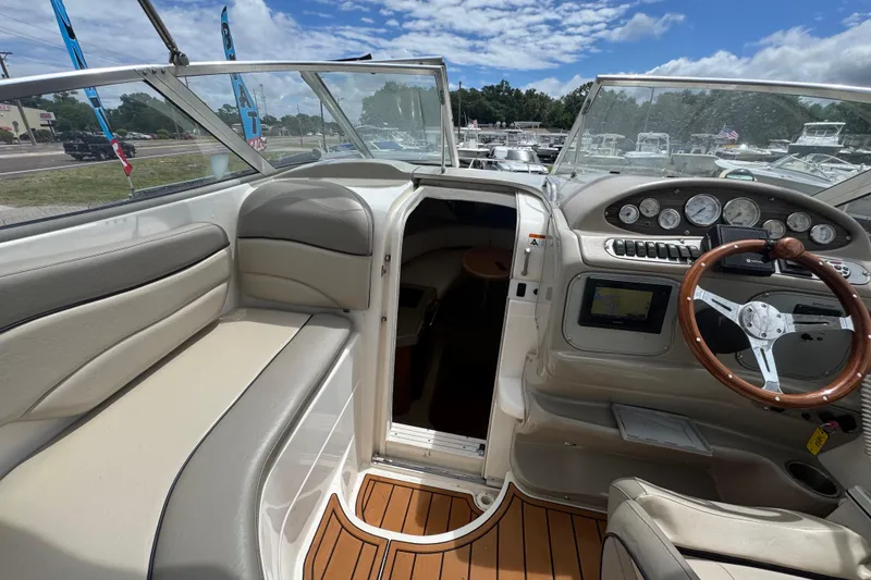 Slide: The Image of 2008 Larson Cabrio 260 boat interior with steering wheel, dashboard, and seating. - 29