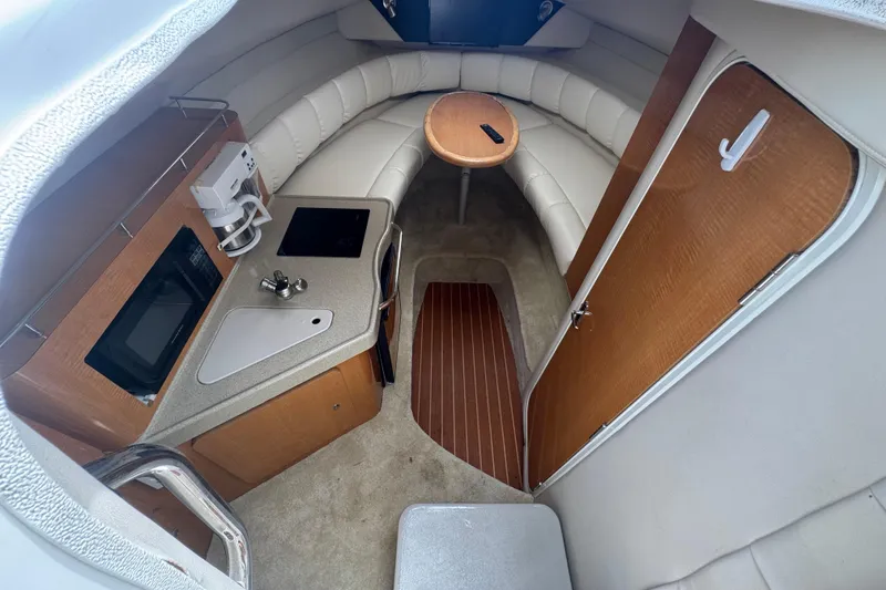 Slide: The Image of Interior of 2008 Larson Cabrio 260 boat with kitchenette and seating area. - 30