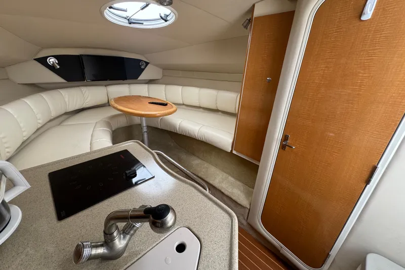 Slide: The Image of Interior of 2008 Larson Cabrio 260 boat with kitchenette and seating area. - 31