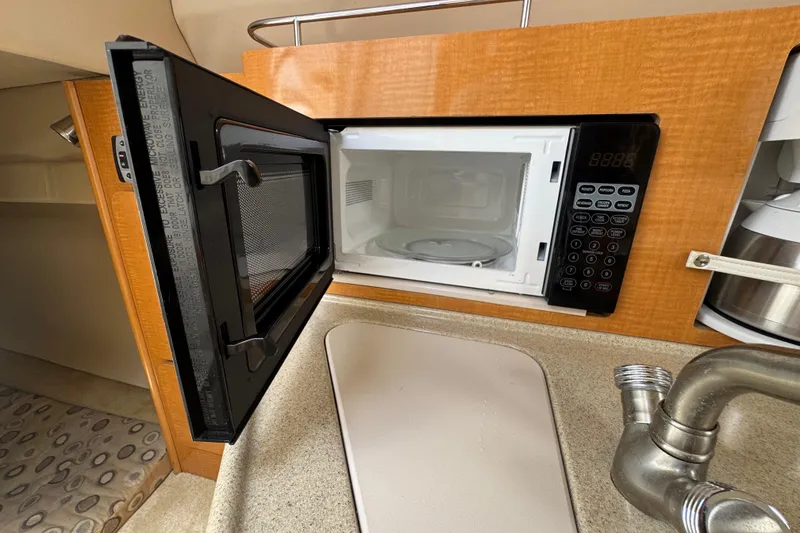 Slide: The Image of Open microwave in 2008 Larson Cabrio 260 boat kitchen area. - 41